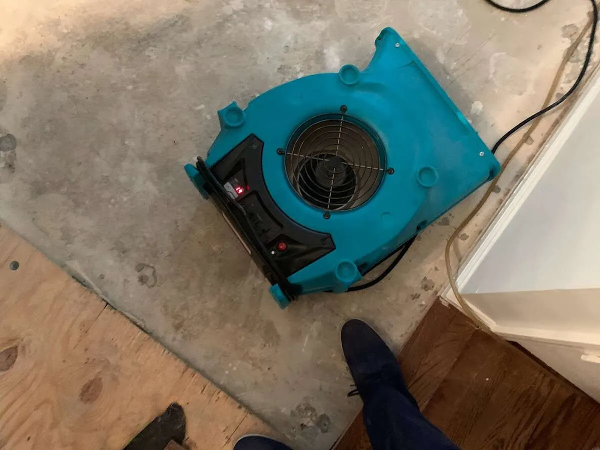 Air mover drying subfloor during Commercial Water Damage Restoration in Jenks